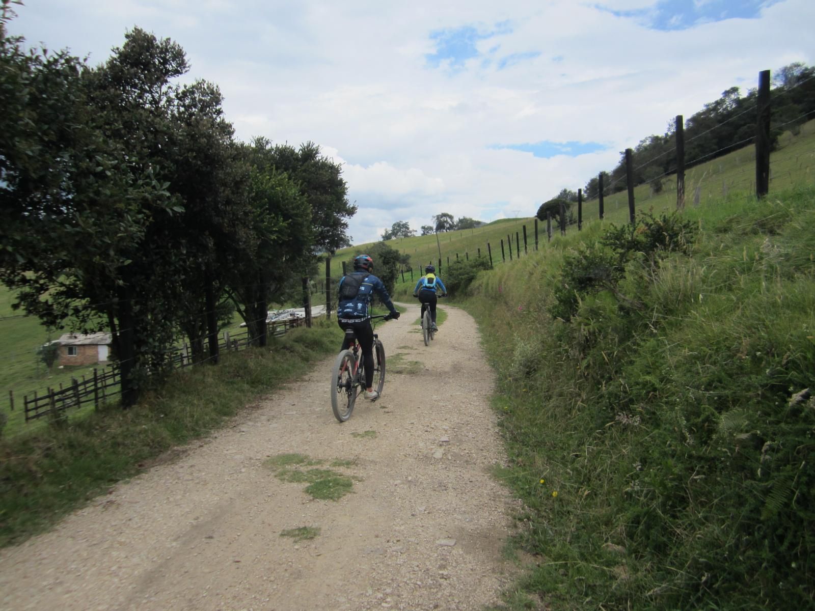 Two cyclists on a gravel country road near Guatavita