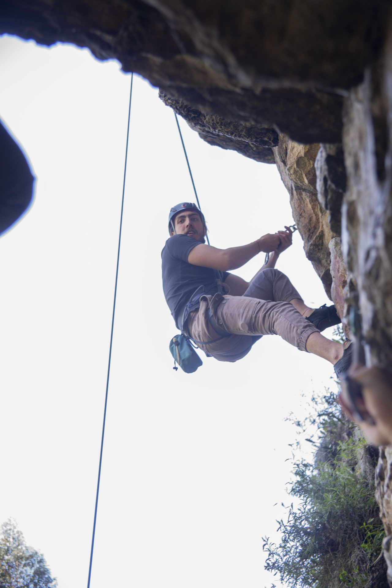 Climber on a rope against a sandstone wall in Suesca